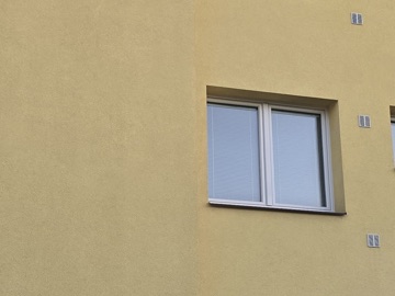 Tentýž dům po vyčištění metodou Soft Wash - fasáda jednolitě čistá ve večerním světle